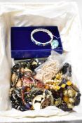 A basket of mixed costume jewellery, to include an amber coloured necklace, bangles, and other