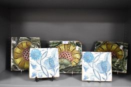 Five William De Morgan style glazed pottery tiles decorated with stylised flowers