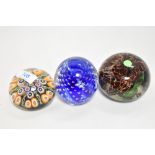 A group of three decorative 20th century glass paperweights, to include controlled bubble,