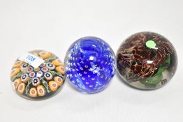 A group of three decorative 20th century glass paperweights, to include controlled bubble,