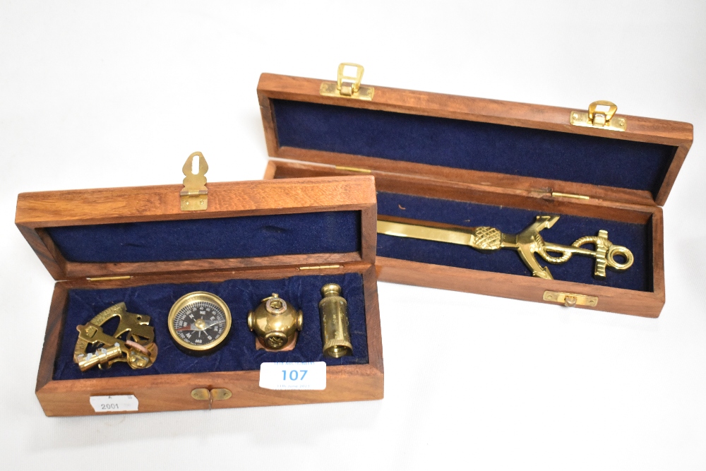 A group of four modern brass miniature nautical themed items, sextand, compass, divers helmet and