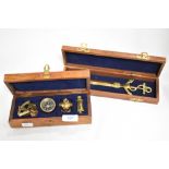 A group of four modern brass miniature nautical themed items, sextand, compass, divers helmet and
