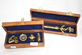 A group of four modern brass miniature nautical themed items, sextand, compass, divers helmet and