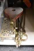 A vintage brass trivet, a set of wooden bellows, and a companion set.