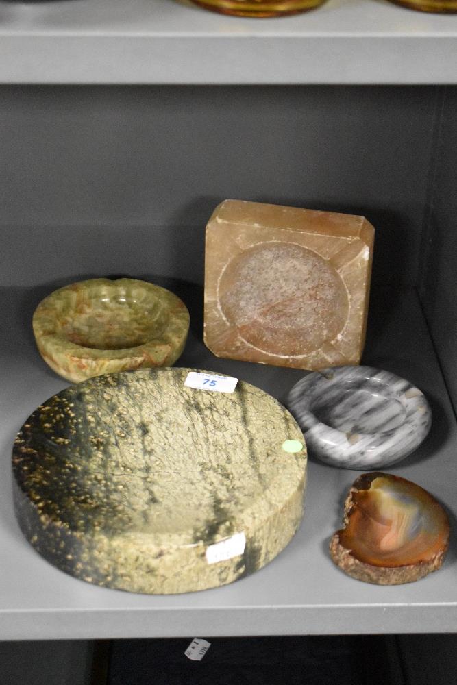 Five stone ashtrays of different forms, to include a circular onyx ashtray