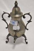 A miniature ornamental pewter samovar, of baluster form with domed finial topped cover over scrolled