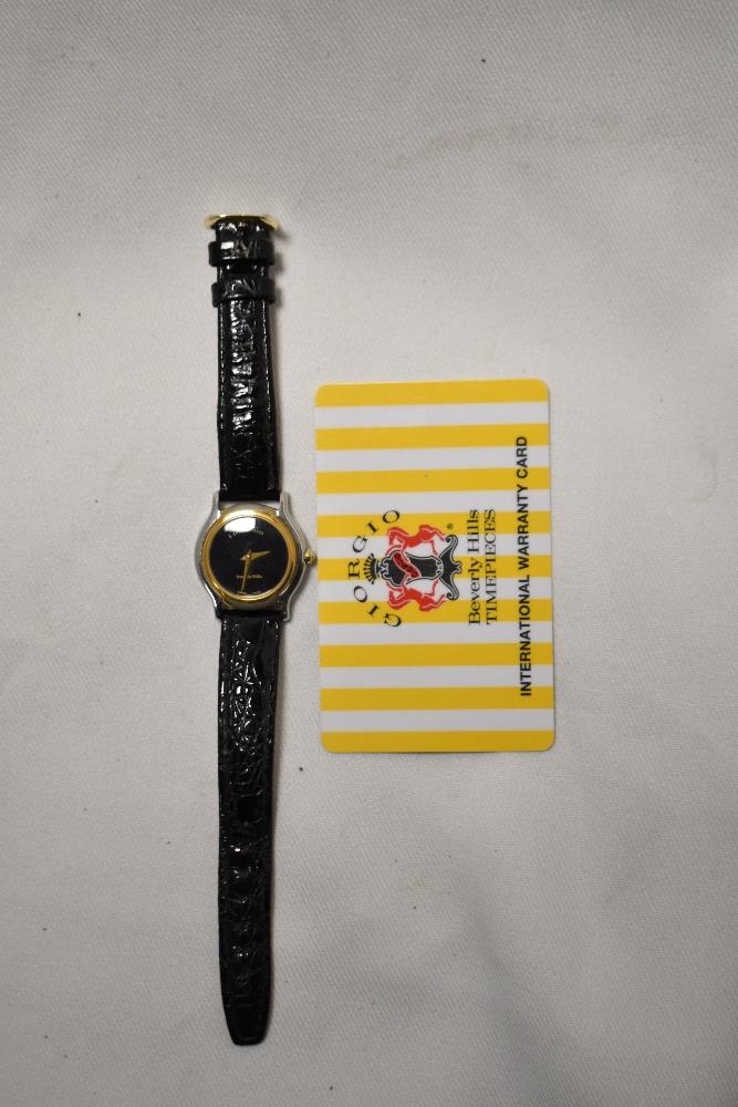 A Giorgio Beverly Hills timpiece with international warranty card