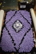 An as new, handmade peggy/ proddy rug in purple, black and white.