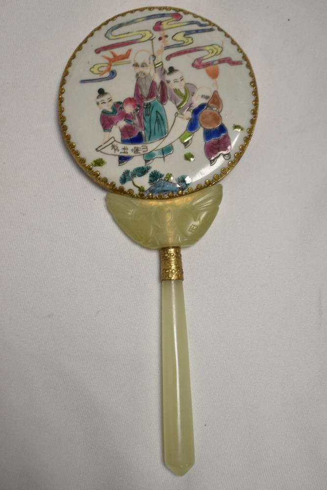 A Chinese porcelain and carved green stone hand mirror, the circular 'head' with mirrored section - Image 2 of 3