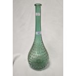 An interesting green glass vase, having dimple decoration, long neck, and measuring 40cm tall