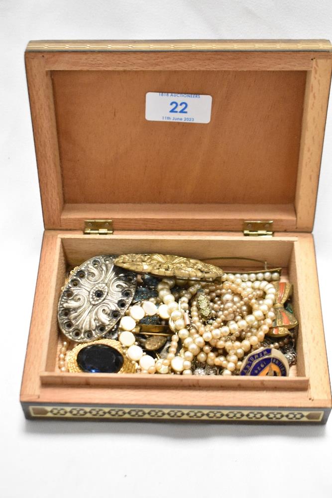An Eastern marquetry box containing various jewellery, including strings of pearls, metal