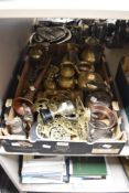 A box full of vintage brass and copper ware, including horse head stirrup cups, horse brasses,