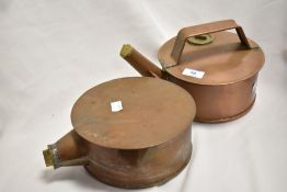 A copper stove top kettle with brass screw covers, sold together with a similar warming pan, both