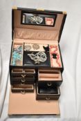 A small quantity of costume jewellery and crowns in a smart leather compartmented jewellery box
