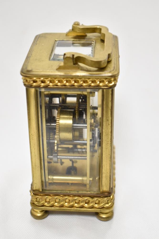 An early 20th Century French carriage clock, with shaped handle, bevelled glass case, a hand painted - Image 2 of 3