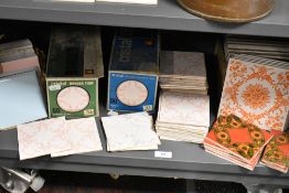A selection of various decorative ceramic tiles, some retaining the original packaging.