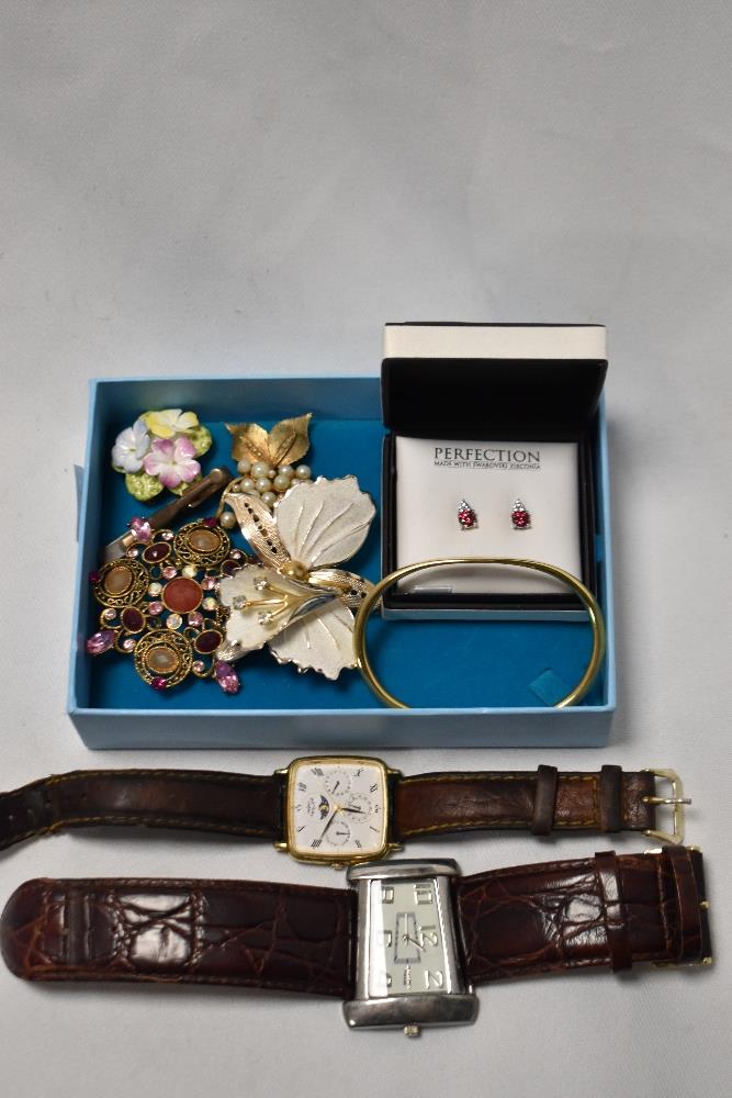 A box containing a Speedster Premier wristwatch, a Rotary moon phase wristwatch, and decorative