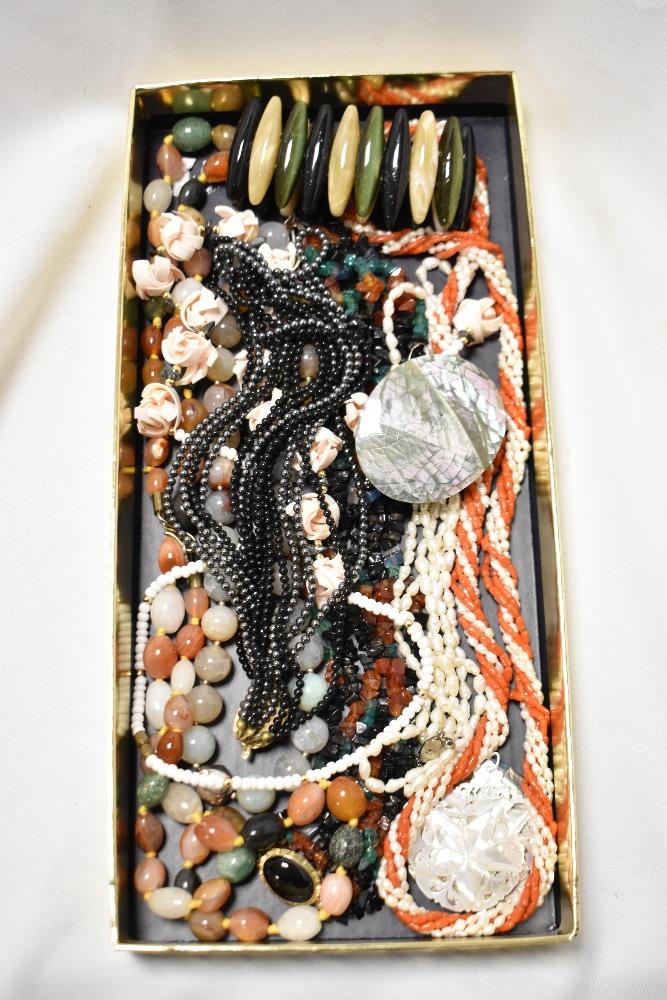 A box of mixed costume jewellery necklaces and pendants