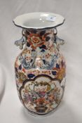 A 20th Century Chinese vase, decorated in Imari colours, having a flared rim, and six figure