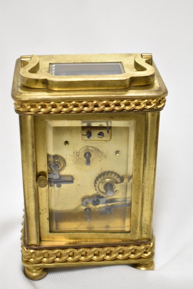 An early 20th Century French carriage clock, with shaped handle, bevelled glass case, a hand painted - Image 3 of 3