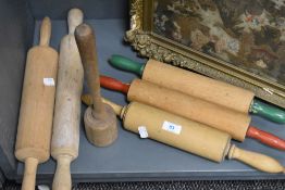 A group of vintage rolling pins and posser