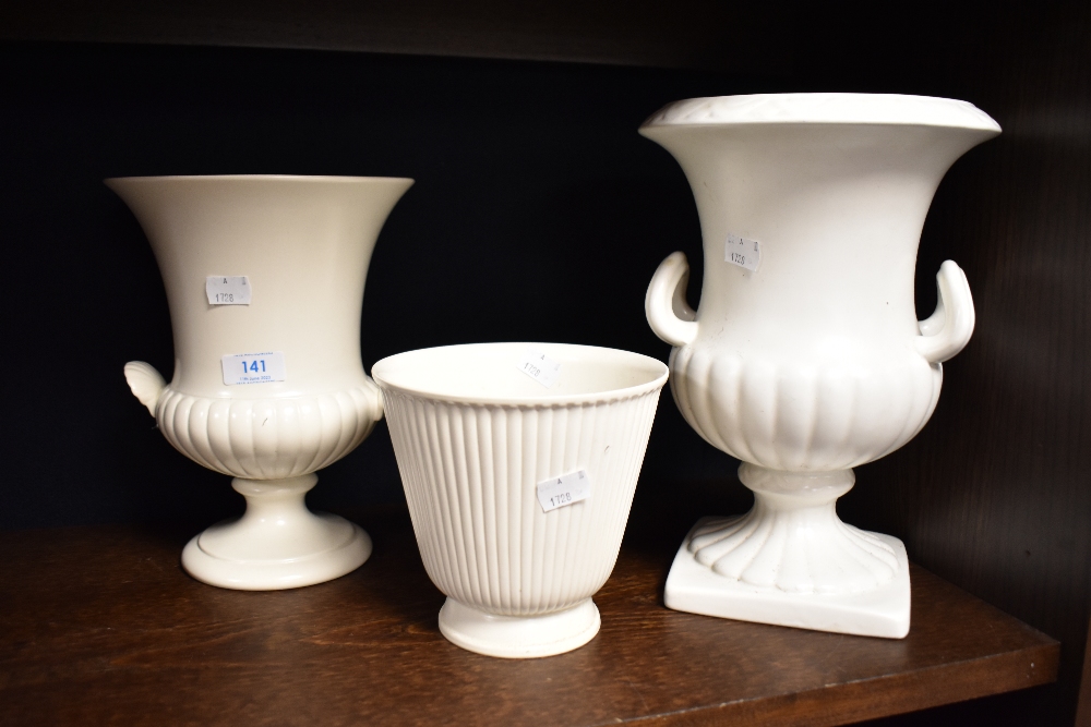 A moulded Wedgwood two handled urn, a Wedgwood planter and a shorter and son two handled urn, all