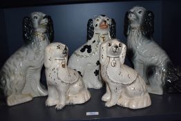 Two pairs of traditional Staffordshire dogs and one similar.