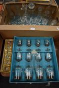 A collection of glass decanters, jars and drinking glasses including some boxed.