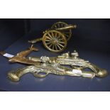 Four vintage novelty ornamental brasses, comprising; cannon, plane and two pistols.