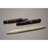 Two vintage fountain pens, one miniature with marbled effect barrel and similar retracting pencil,