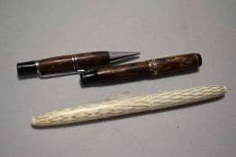 Two vintage fountain pens, one miniature with marbled effect barrel and similar retracting pencil,