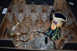 A small box of glassware comprising cut glass wine and spirit glasses, moulded tea cups and