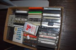 A carton of cassette tapes of various genre including Best of Reggae Rock, Elaine Paige 'The Queen