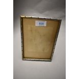 An Indian white metal photograph frame, of rectangular form with rope-twist type decoration,