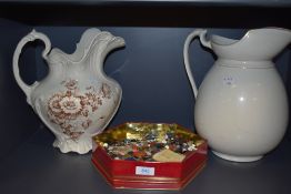 Two large wash jugs and a box of assorted buttons.