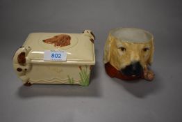A mid century DBC ware trinket box with relief spaniels to sides and lid, and a novelty pipe smoking