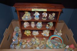 A collection of 'Cherished Teddies' by Enesco, anthropomorphic bear figures, with wooden display