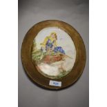 A hand painted plate of oval form, depicting shepherdess to centre.