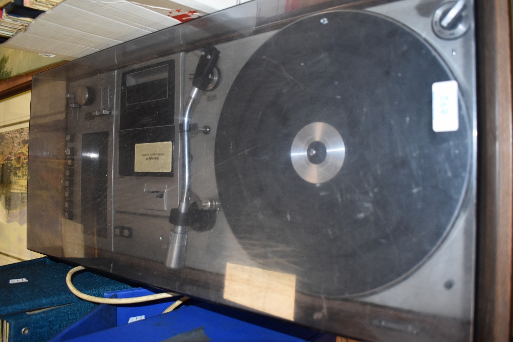 A vintage Sharp SG- 309H cassette and record player music centre. In good condition with dust