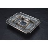 A Victorian silver inkstand, of dished rectangular form with moulded rim, re-entrant corners and