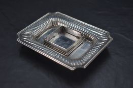 A Victorian silver inkstand, of dished rectangular form with moulded rim, re-entrant corners and