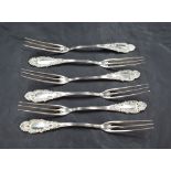 A set of six American sterling silver dessert or pastry forks, each having three slender tines,