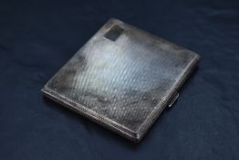 A Queen Elizabeth II silver cigarette case, of hinged rectangular form, engine-turned throughout,