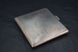 A 1930's silver cigarette case, of hinged rectangular form, engine-turned throughout, marks for