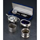 A group of mixed silver items items, comprising silver salt, mustard, two napkin rings and