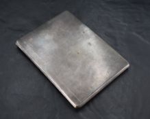 A George V silver cigarette case, of piano-hinged rectangular form with subtle engine-turned surface
