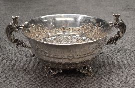 An impressive Victorian silver two-handled bowl, of circular form with finely embossed bellflower,