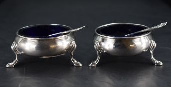 A pair of Victorian silver salts, of circular form with Bristol blue glass liners and stepped