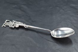 A Queen Elizabeth II silver golfing interest spoon, the club handle and ball terminal surmounted
