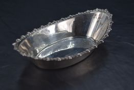 An Edwardian silver dish, of oval form with gadrooned rim, marks for Sheffield 1901, maker James